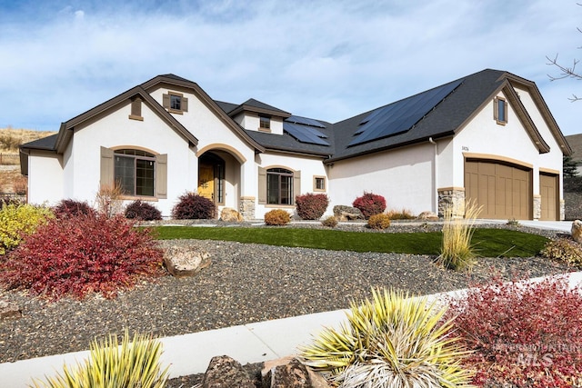 french country inspired facade featuring a garage