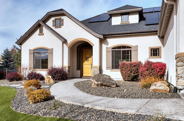 view of front of property featuring solar panels