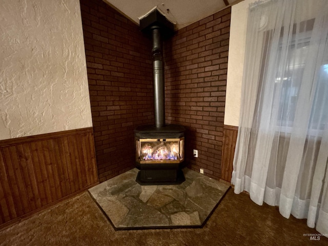2934 SW Smith Rd, Mountain Home, ID 83647 - room details with wood walls, carpet, and a wood stove