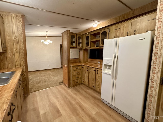 2934 SW Smith Rd, Mountain Home, ID 83647 - kitchen with a chandelier, white refrigerator with ice dispenser, light hardwood / wood-style floors, and hanging light fixtures