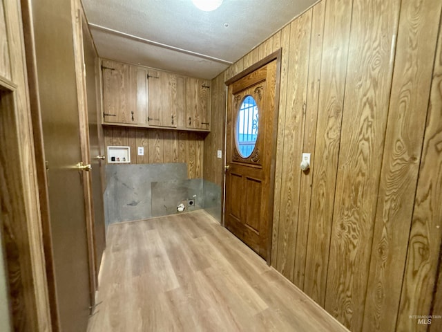 2934 SW Smith Rd, Mountain Home, ID 83647 - laundry area with wood walls, hookup for a washing machine, cabinets, and light wood-type flooring