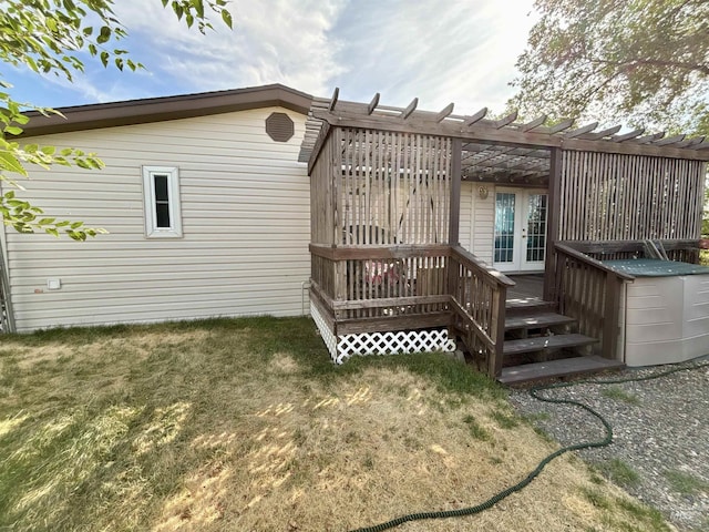 2934 SW Smith Rd, Mountain Home, ID 83647 - back of property with a wooden deck, a lawn, and french doors