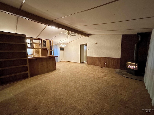 2934 SW Smith Rd, Mountain Home, ID 83647 - basement with ceiling fan, wooden walls, carpet, and a wood stove