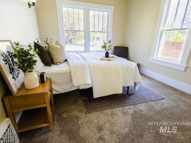 carpeted bedroom with baseboards and visible vents