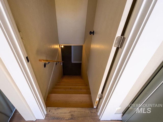stairs with wood finished floors