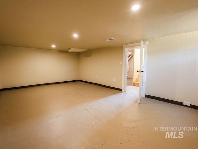 empty room with recessed lighting, baseboards, and concrete floors