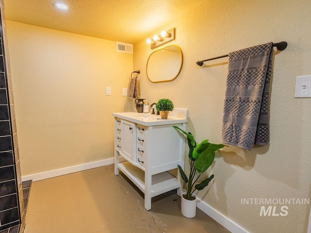 bathroom featuring baseboards, visible vents, concrete floors, and vanity