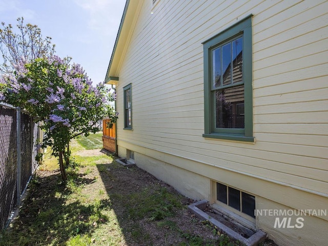 view of side of property featuring fence