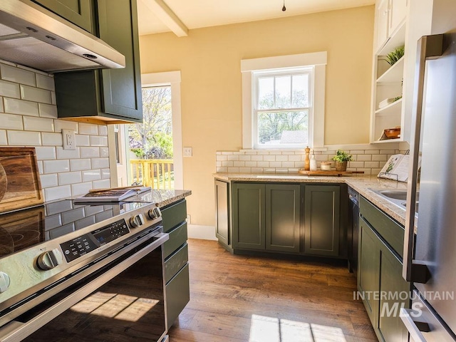 kitchen with decorative backsplash, wood finished floors, under cabinet range hood, light stone counters, and stainless steel range with electric cooktop