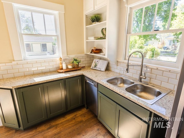 kitchen featuring stainless steel dishwasher, open shelves, wood finished floors, plenty of natural light, and a sink