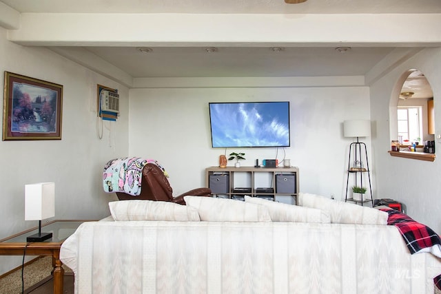 134 Maple Ave, Hansen, ID 83334 - living room with arched walkways, baseboards, and an AC wall unit