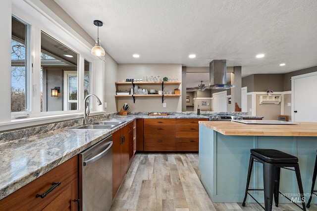 kitchen featuring island exhaust hood, stainless steel dishwasher, brown cabinetry, and a sink