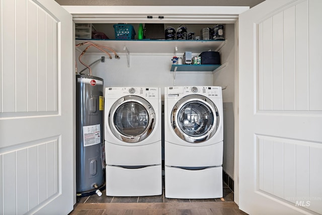 clothes washing area featuring water heater, laundry area, and washing machine and clothes dryer