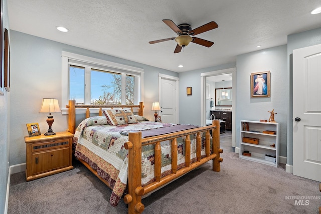 bedroom featuring connected bathroom, carpet, recessed lighting, a textured ceiling, and a ceiling fan