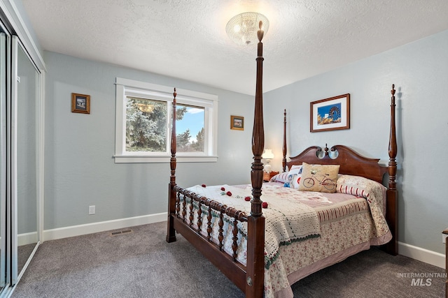 carpeted bedroom with a closet, visible vents, a textured ceiling, and baseboards