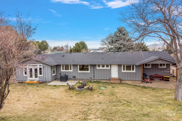 rear view of property with french doors, a lawn, board and batten siding, and a patio area