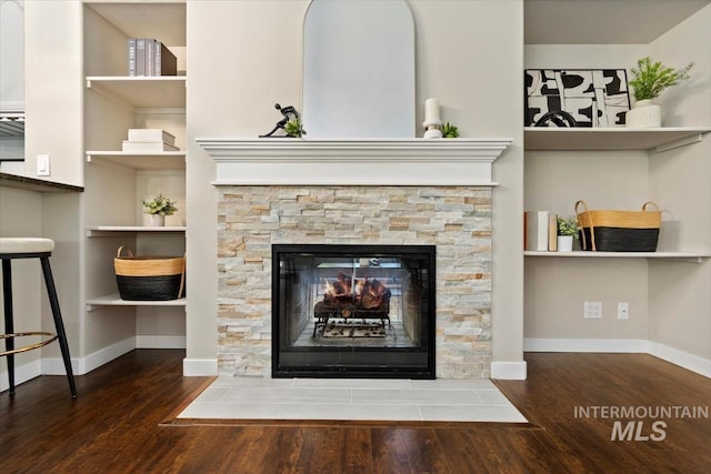 6472 S Liveoak Pl, Boise, ID 83716 - detailed view of wood finished floors, baseboards, a stone fireplace, and built in features