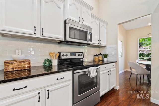 6472 S Liveoak Pl, Boise, ID 83716 - kitchen with appliances with stainless steel finishes, dark wood finished floors, white cabinets, dark stone counters, and backsplash