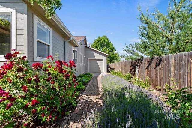 6472 S Liveoak Pl, Boise, ID 83716 - view of yard featuring a garage and driveway
