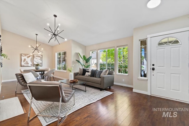 6472 S Liveoak Pl, Boise, ID 83716 - living room with a chandelier, baseboards, wood finished floors, and vaulted ceiling