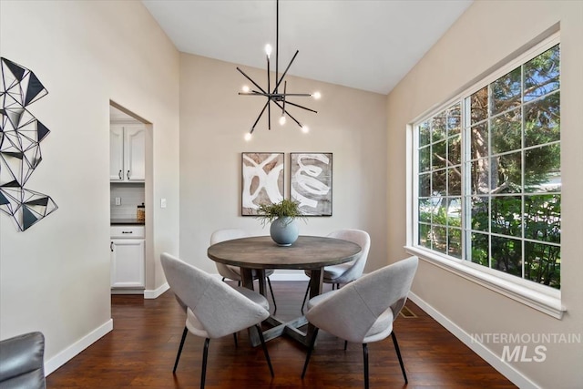 6472 S Liveoak Pl, Boise, ID 83716 - dining space with a chandelier, dark wood-style flooring, baseboards, and vaulted ceiling
