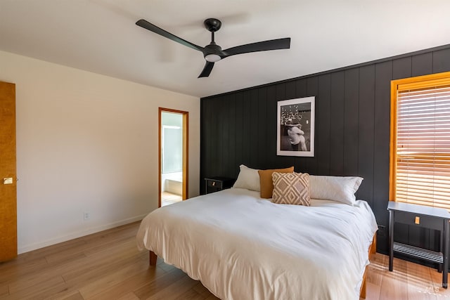 12281 W Norway St, Boise, ID 83713 - bedroom with light wood finished floors, baseboards, ceiling fan, and ensuite bath