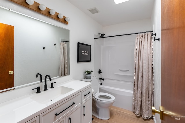 12281 W Norway St, Boise, ID 83713 - full bath with toilet, shower / bath combo with shower curtain, vanity, and wood finished floors