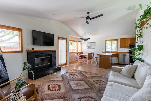 12281 W Norway St, Boise, ID 83713 - living room featuring a brick fireplace, lofted ceiling, light wood finished floors, a ceiling fan, and baseboards