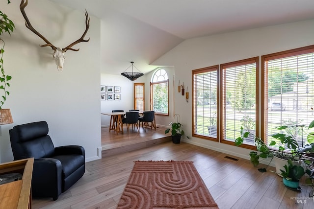 12281 W Norway St, Boise, ID 83713 - living area featuring light wood-style flooring, lofted ceiling, and baseboards