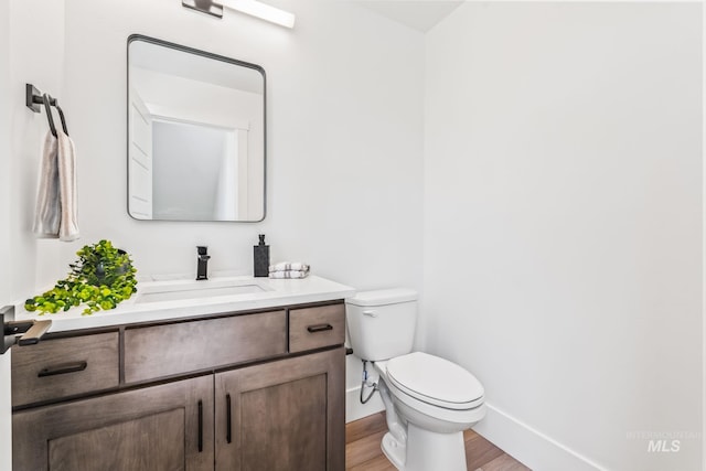 2919 W Jordan Unit 2, Boise, ID 83702 - bathroom featuring vanity, wood finished floors, toilet, and baseboards