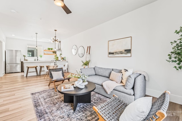 2919 W Jordan Unit 2, Boise, ID 83702 - living room featuring a ceiling fan, light wood-style floors, and baseboards
