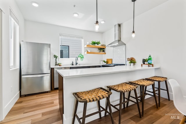 2919 W Jordan Unit 2, Boise, ID 83702 - kitchen featuring appliances with stainless steel finishes, wall chimney exhaust hood, light wood-type flooring, light countertops, and recessed lighting