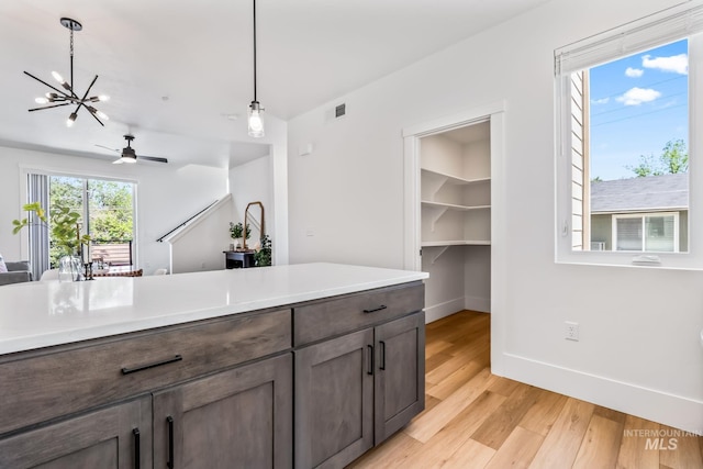 2919 W Jordan Unit 2, Boise, ID 83702 - kitchen with light wood-style flooring, baseboards, hanging light fixtures, open floor plan, and a ceiling fan