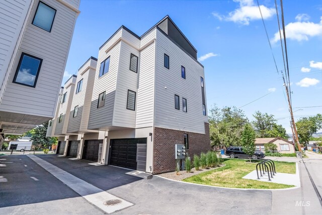 2919 W Jordan Unit 2, Boise, ID 83702 - view of property exterior with an attached garage, driveway, and brick siding