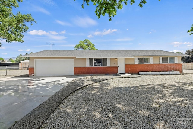 406 N Pine St, Emmett, ID 83617 - single story home with brick siding, a garage, and concrete driveway