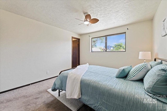 406 N Pine St, Emmett, ID 83617 - bedroom with carpet floors, baseboards, ceiling fan, and a textured ceiling