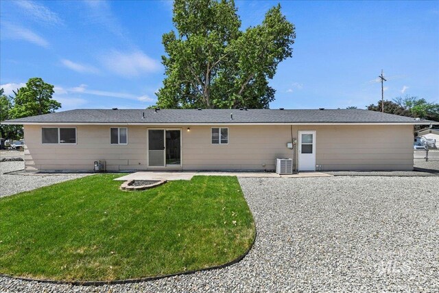 406 N Pine St, Emmett, ID 83617 - back of house featuring central AC, a patio area, and a lawn