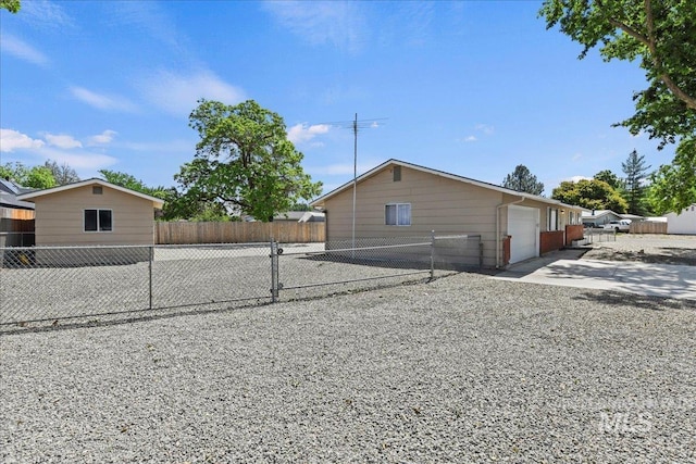 406 N Pine St, Emmett, ID 83617 - view of side of home with concrete driveway and an attached garage