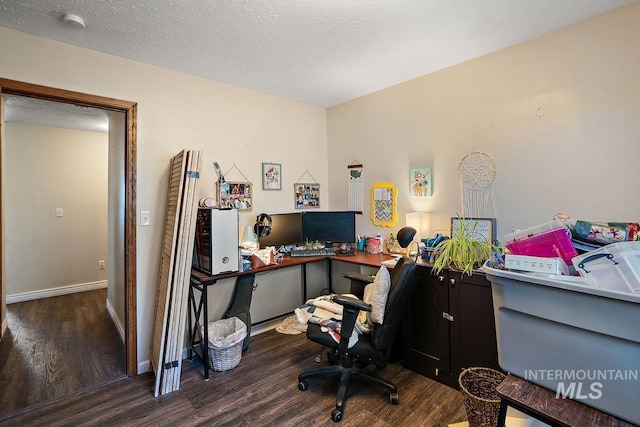 home office with a textured ceiling and dark wood-type flooring