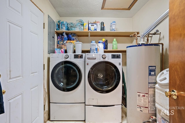 washroom with washer and dryer, a textured ceiling, electric panel, and water heater