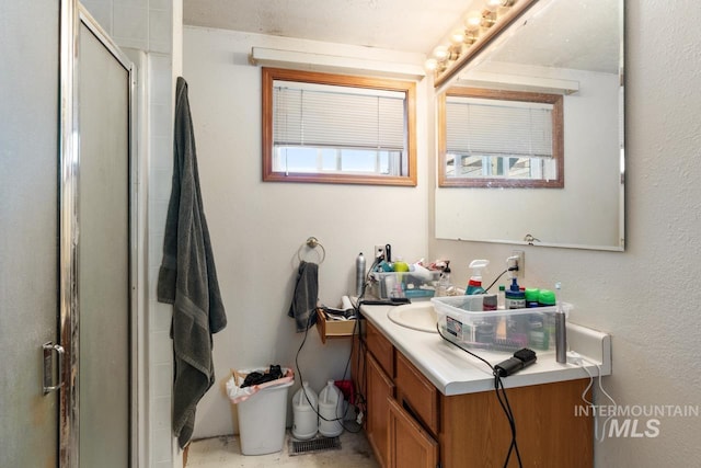 bathroom with vanity and a shower with shower door