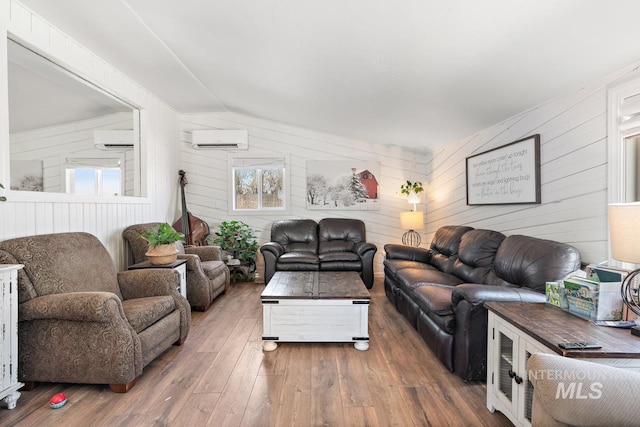 living room with dark hardwood / wood-style flooring, vaulted ceiling, a healthy amount of sunlight, and wood walls