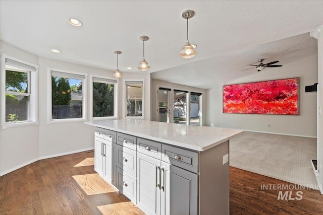 1825 E Seaside Ct, Boise, ID 83706 - kitchen featuring gray cabinets, open floor plan, decorative light fixtures, a kitchen island, and baseboards