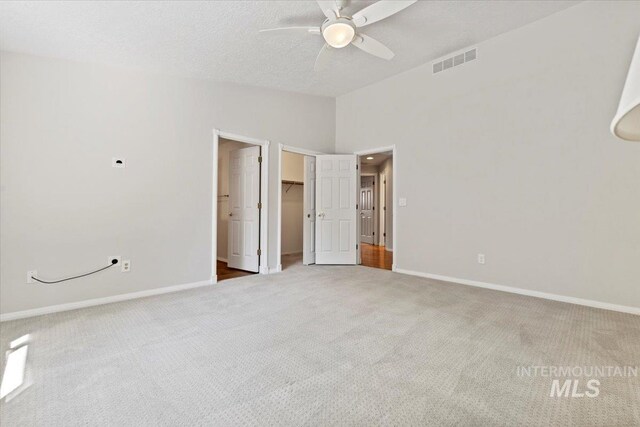 1825 E Seaside Ct, Boise, ID 83706 - unfurnished bedroom with carpet floors, vaulted ceiling, baseboards, a spacious closet, and a ceiling fan