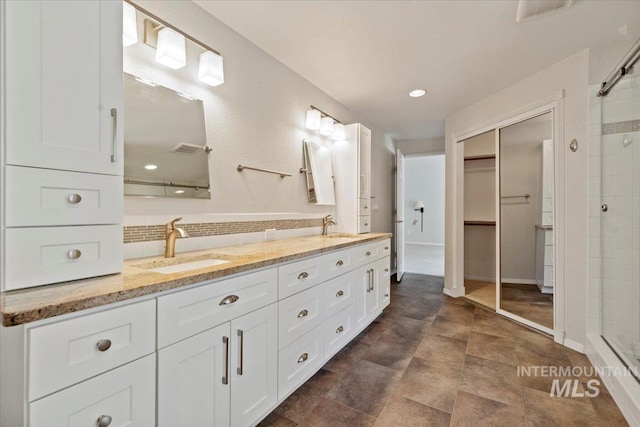 1825 E Seaside Ct, Boise, ID 83706 - bathroom featuring a stall shower, double vanity, and a walk in closet