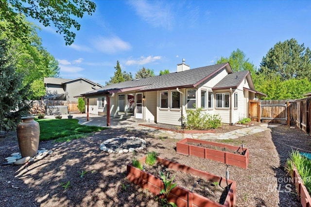 1825 E Seaside Ct, Boise, ID 83706 - rear view of house featuring a garden, a patio, a fenced backyard, a chimney, and a gate