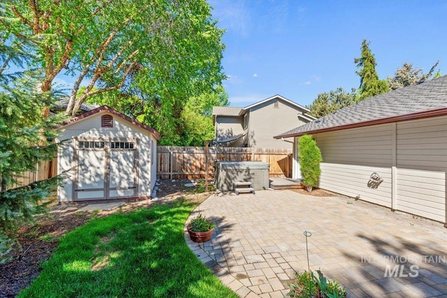 1825 E Seaside Ct, Boise, ID 83706 - view of patio featuring a hot tub, a shed, a fenced backyard, and an outdoor structure
