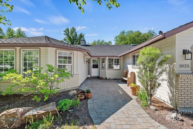 1825 E Seaside Ct, Boise, ID 83706 - property entrance featuring a patio area and a chimney