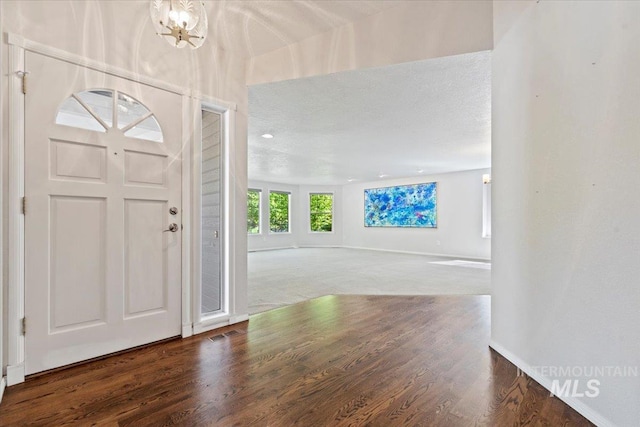 1825 E Seaside Ct, Boise, ID 83706 - entrance foyer featuring a chandelier, wood finished floors, and baseboards