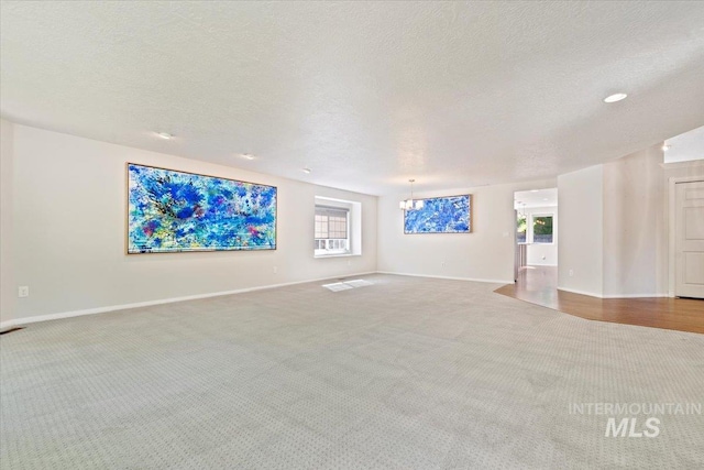 1825 E Seaside Ct, Boise, ID 83706 - carpeted empty room featuring a textured ceiling, baseboards, and a chandelier